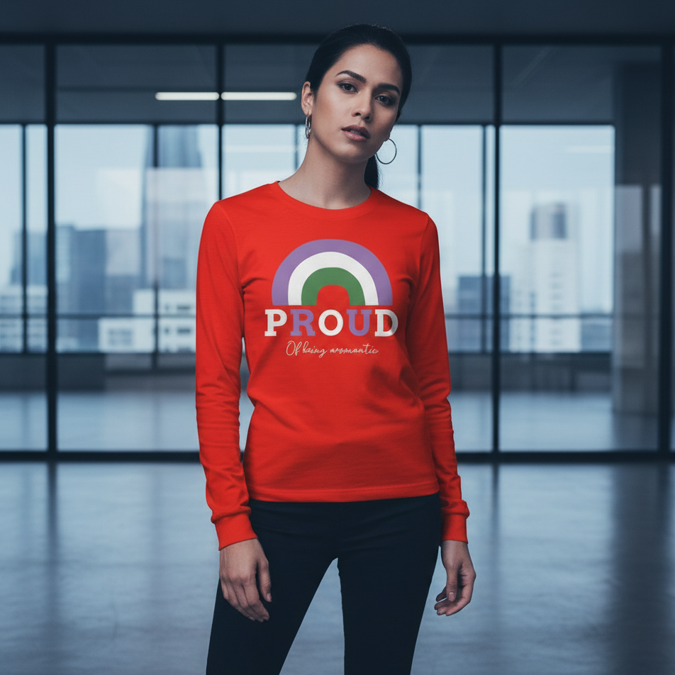 A young woman confidently models the Proud Of Being Aromantic Unisex Long Sleeve T-Shirt, featuring a vibrant rainbow motif and slogan, embodying queer pride and self-expression in a modern office setting.