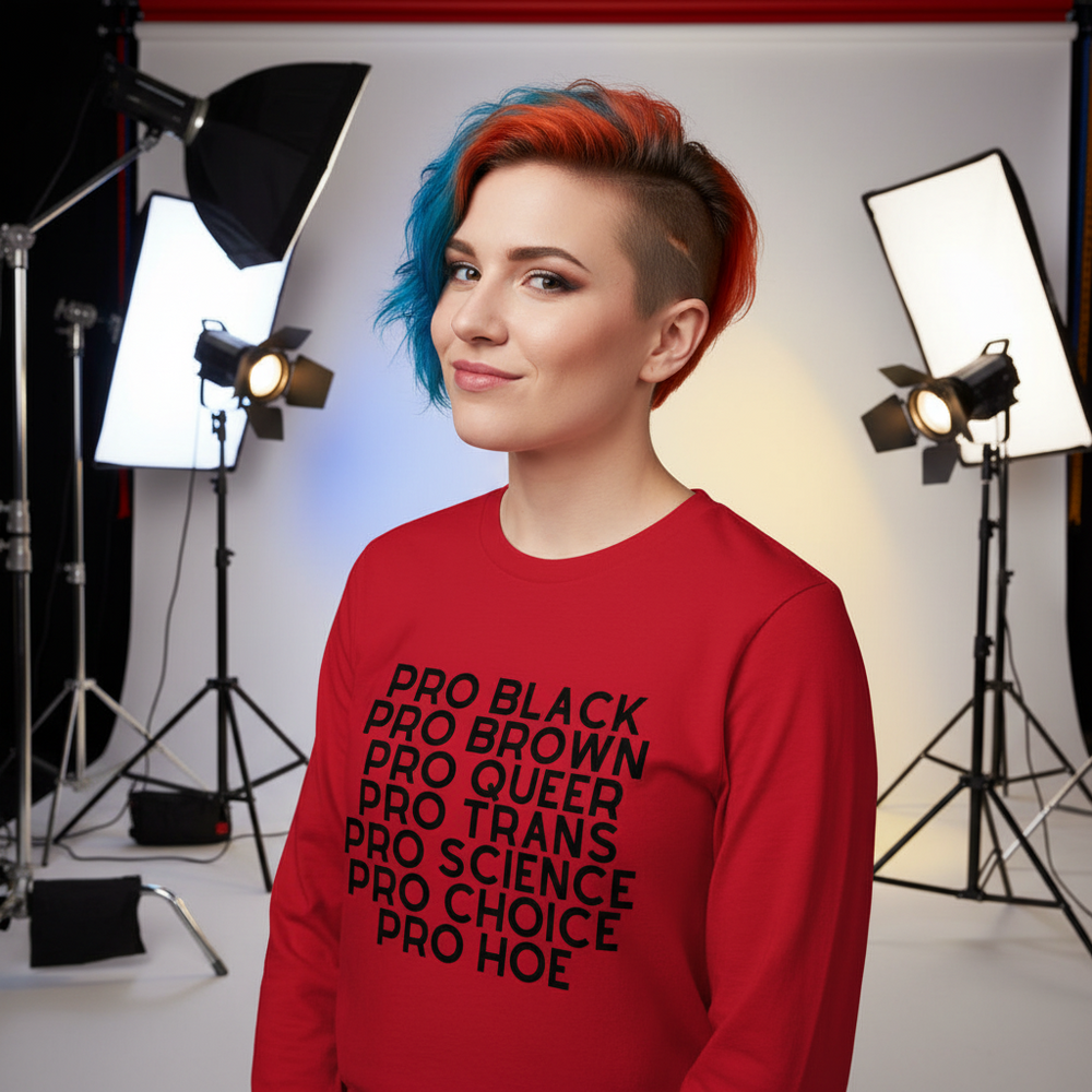 Person with blue-and-red hair models a red long-sleeve shirt reading “PRO BLACK PRO BROWN PRO QUEER PRO TRANS PRO SCIENCE...