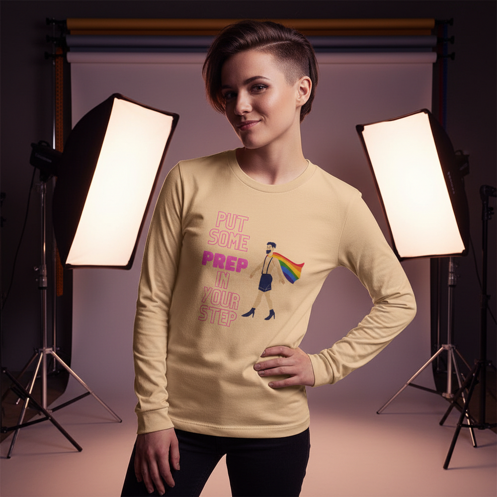 Model wearing a tan long-sleeve shirt reading “PUT SOME PREP IN YOUR STEP” with a rainbow-caped figure