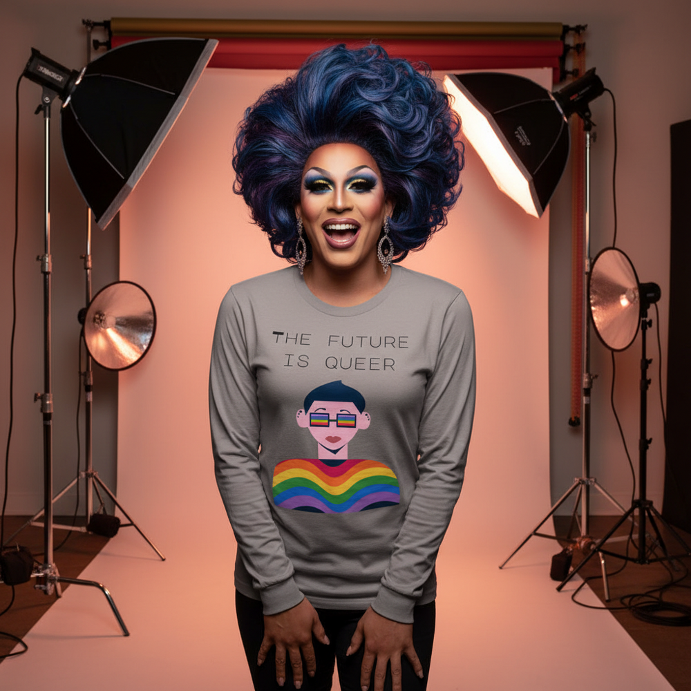 Drag performer models a gray long-sleeve shirt reading “THE FUTURE IS QUEER” with a rainbow graphic.