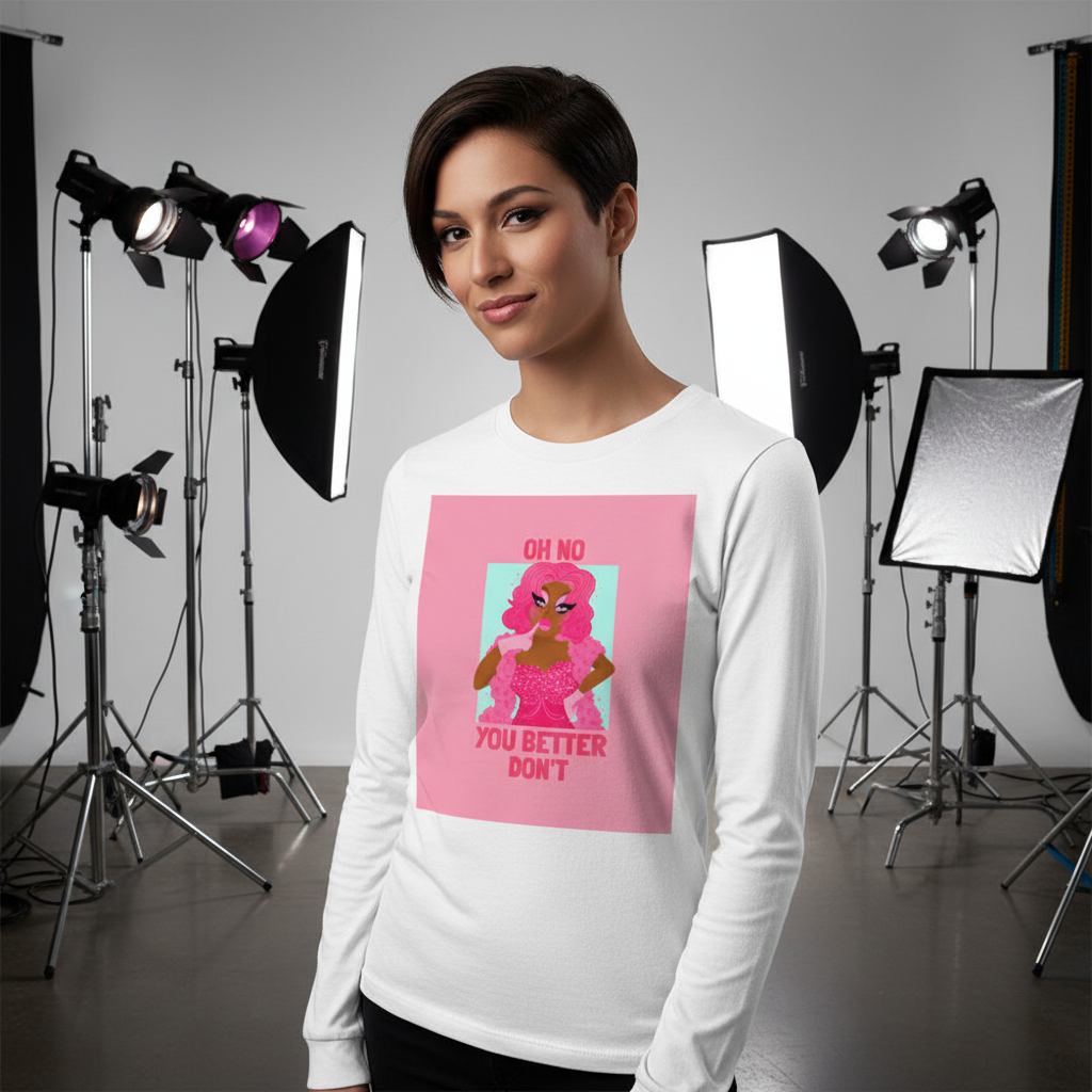Woman in a studio models the Oh No You Better Don't unisex long sleeve tee, featuring a pink-haired drag performer graphic and bold text, embodying queer empowerment and prideful self-expression.