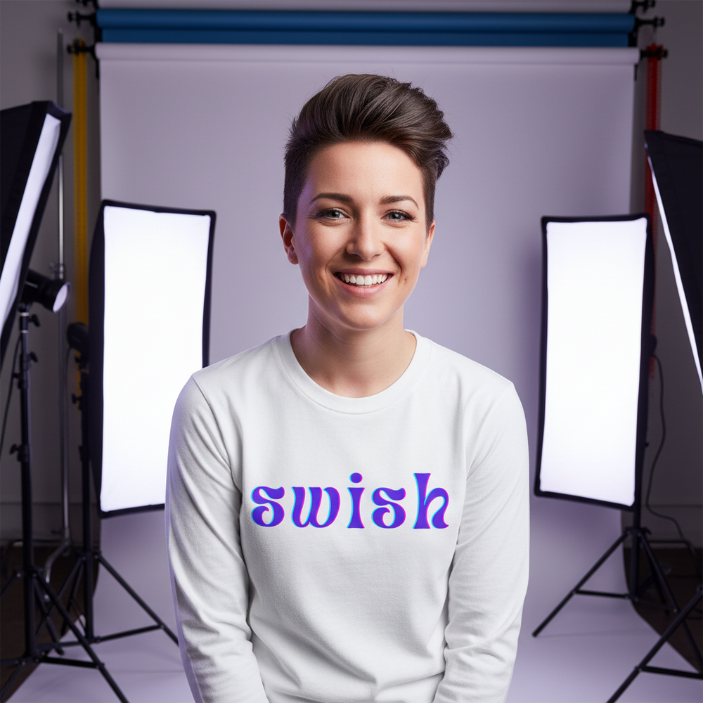 Smiling person wearing a white long-sleeve shirt with colorful “swish” lettering in a studio