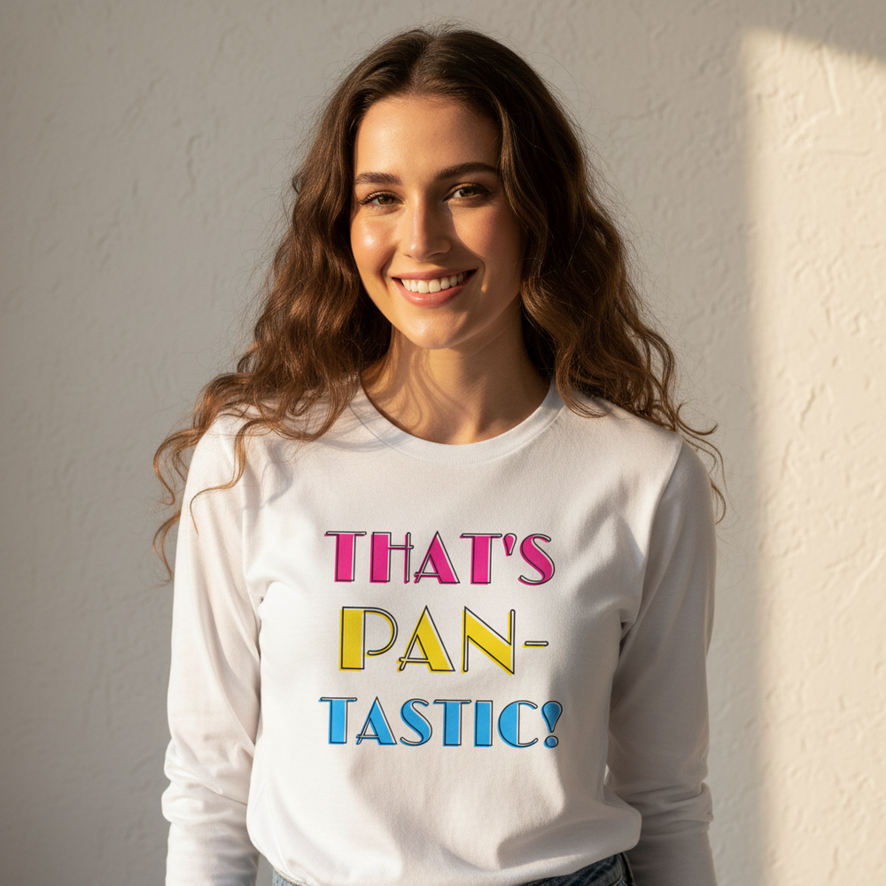 Smiling person modeling a white long-sleeve shirt reading “THAT’S PAN-TASTIC!” in colorful letters