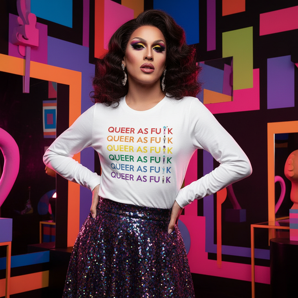 Model wears a white long-sleeve shirt reading “QUEER AS FU*K” in rainbow rows