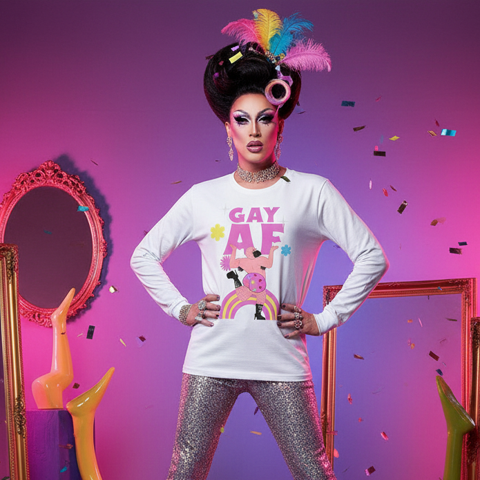 Drag performer in a GAY AF long-sleeve shirt with rainbow and disco character, sparkly pants, and colorful hair accessories, embodies vibrant queer pride and self-expression amidst playful set decor.