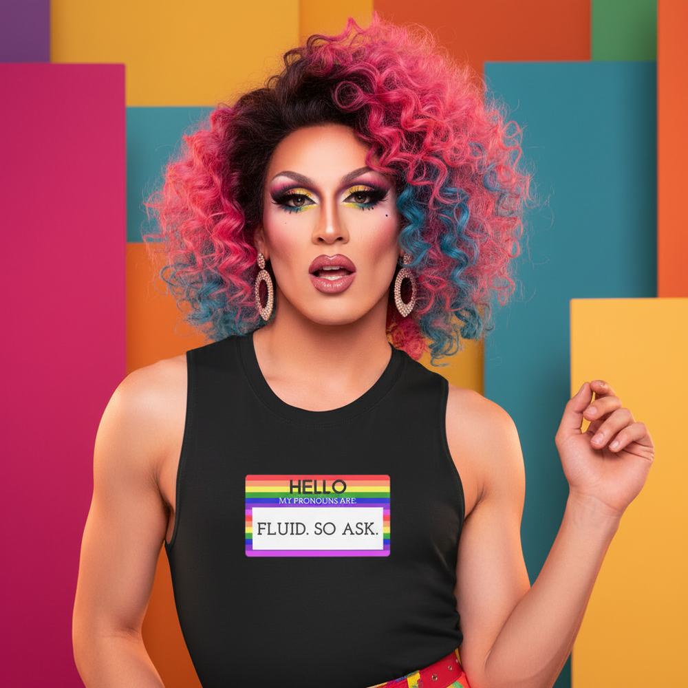 Muscle top with "Hello My Pronouns Are Fluid. So Ask." and rainbow name tag, rocked by a drag queen with pink and blue curls.