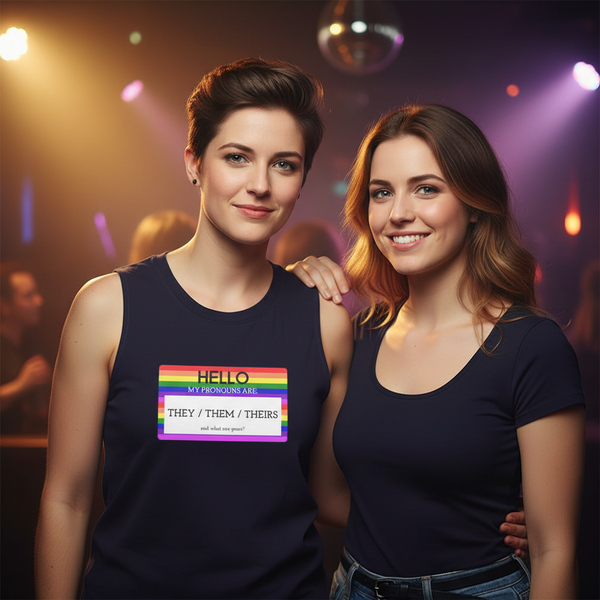 “Hello My Pronouns Are They/Them/Theirs” muscle top on one of two queer folks at a vibrant party, both in dark tops.