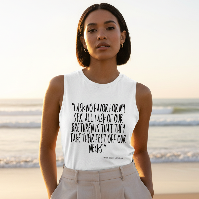 Person wearing a white tank top with a feminist quote at the beach