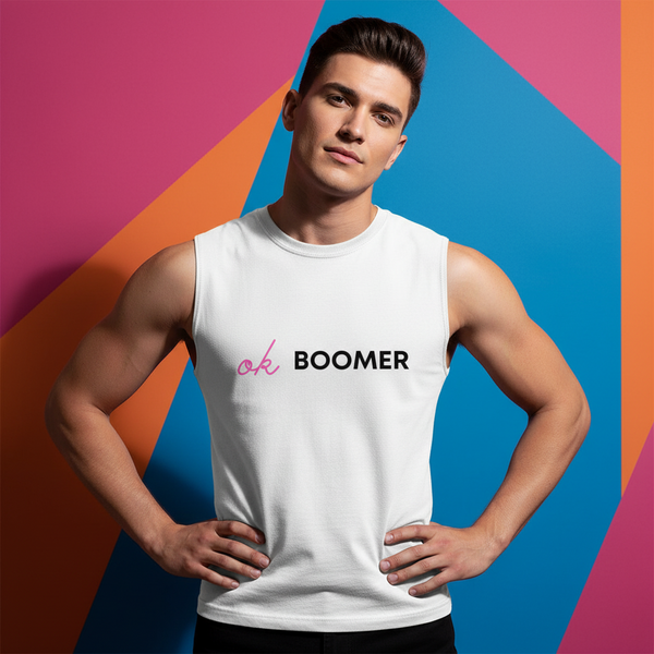 Ok Boomer Muscle Top worn by a young man, hands on hips, pops against a bold pink, orange, and blue geometric background.