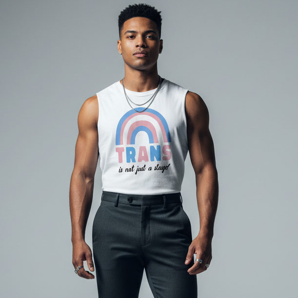 A young person models the Trans Is Not Just A Stage! Muscle Tank, showcasing bold blue-pink-white stripes and empowering text. This sleeveless top embodies pride, confidence, and self-expression.