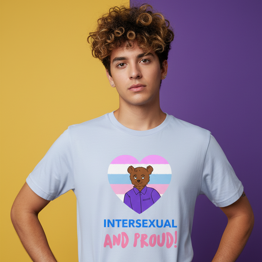 Front-view model wearing a pale blue T-shirt reading “INTERSEXUAL AND PROUD!” with a bear in a striped heart