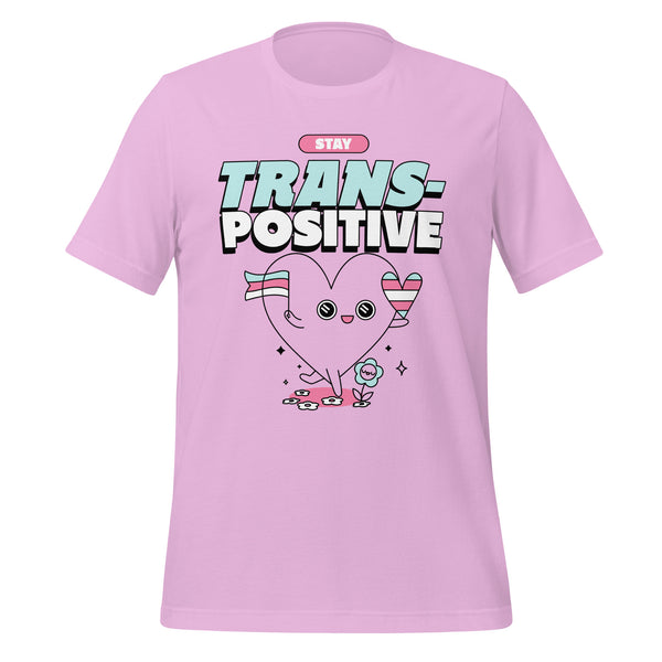 Pink Stay Trans-Positive T-shirt with “STAY TRANS-POSITIVE” over a smiling heart in trans flag stripes and bright sparkles.