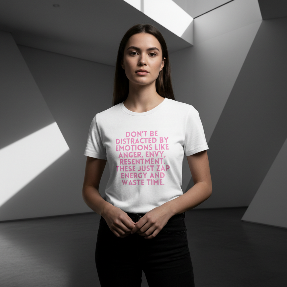 Unisex cotton pride tee with “Don’t Be Distracted by Emotions” in pink text, worn by a woman indoors in a minimalist space.