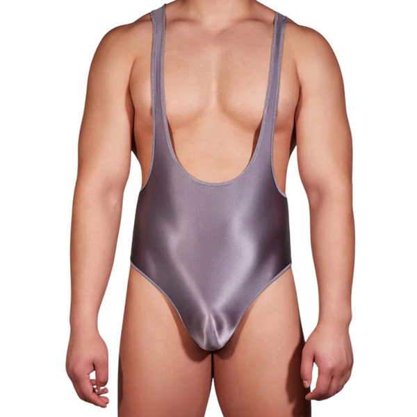 Front view of a model wearing a metallic gray men's bodysuit with a deep scoop neckline