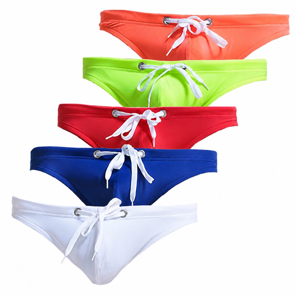 Five front-facing swim briefs in coral, lime, red, navy, and white with white drawstrings