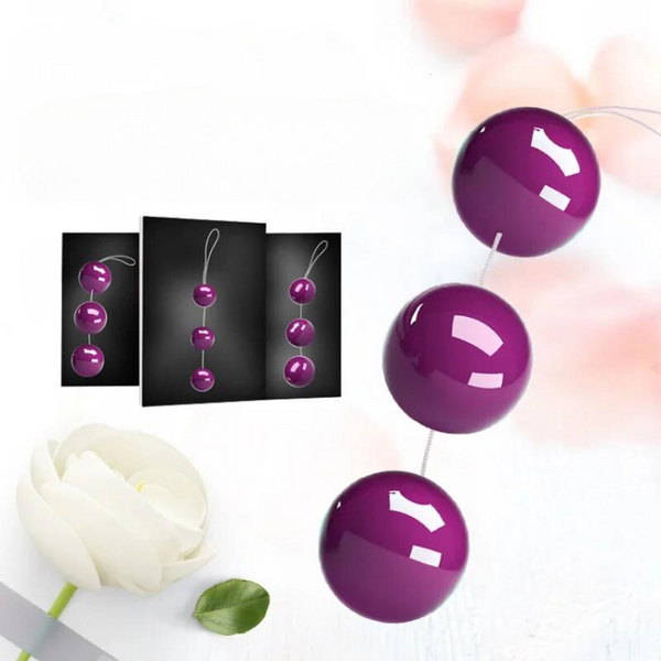 Three glossy purple kegel balls connected by a cord, with product cards in the background