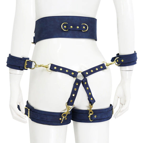 Front view of a navy-blue cage body harness with gold hardware on a mannequin