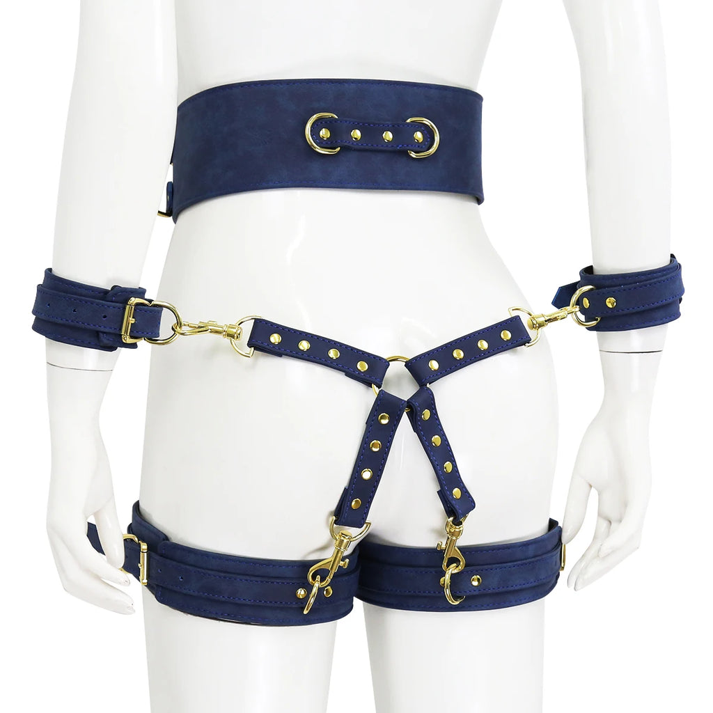 Front view of a navy-blue cage body harness with gold hardware on a mannequin