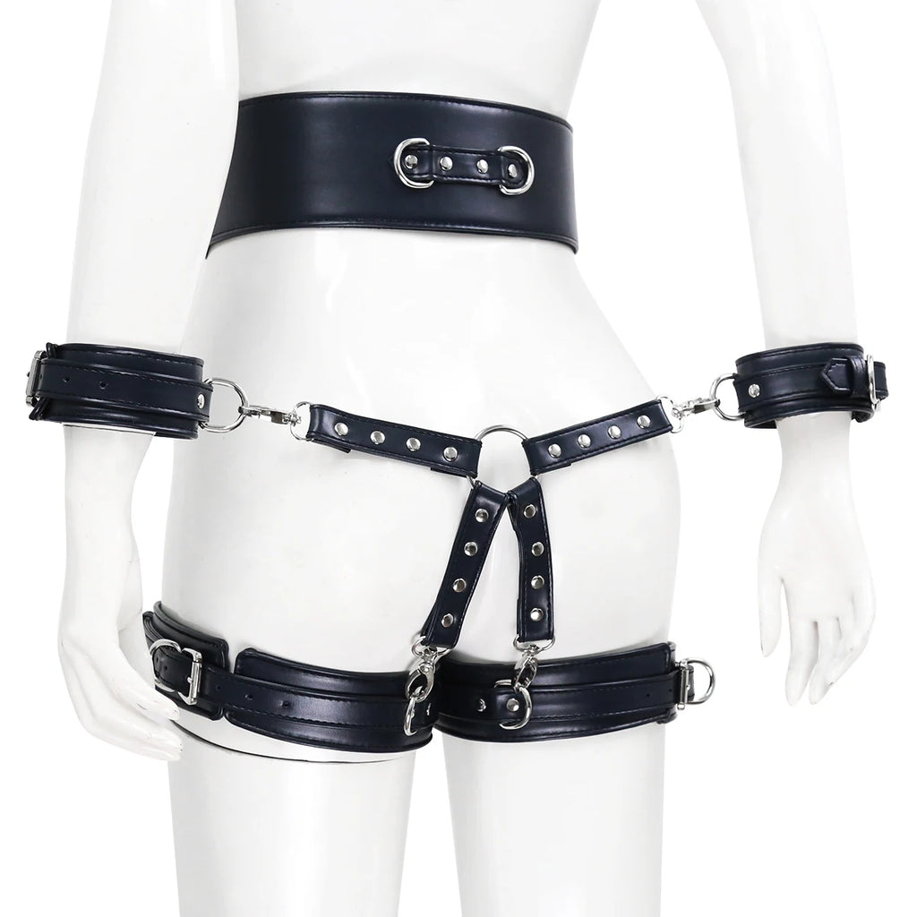 Front view of a black faux-leather body harness on a white mannequin