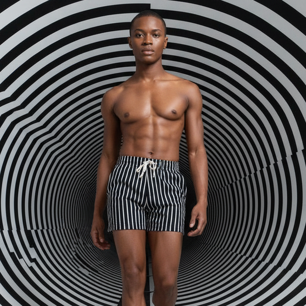 Front-facing model wearing black shorts with thin white vertical stripes and a drawstring