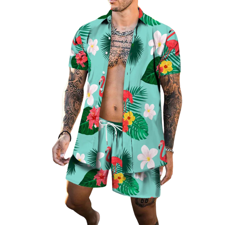 Model wearing a turquoise tropical shirt and shorts set with flamingos, flowers, and palm leaves
