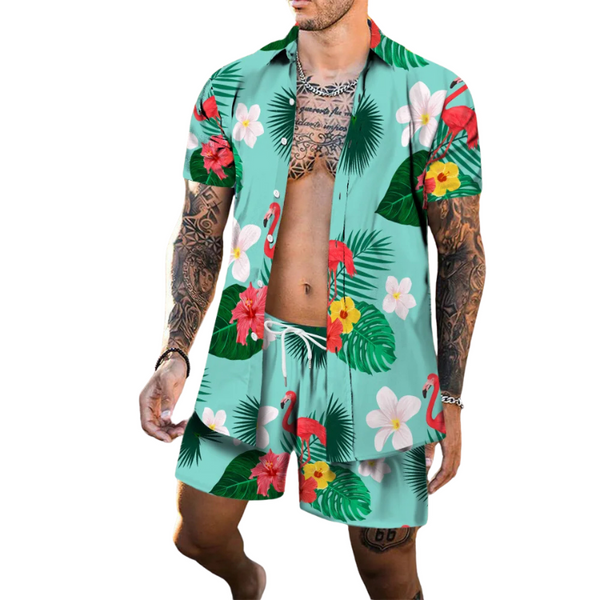 Model wearing a turquoise tropical shirt and shorts set with flamingos, flowers, and palm leaves