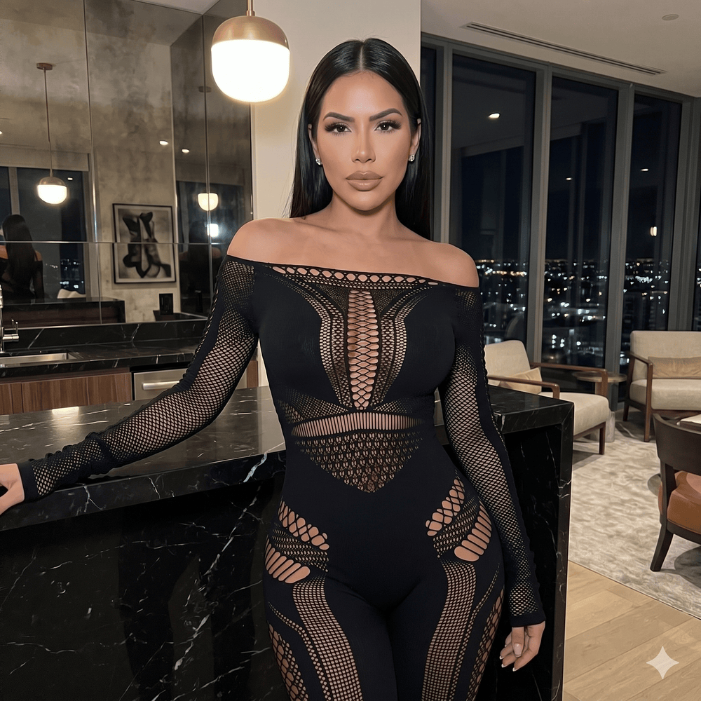 Front-facing model wearing a black off-shoulder mesh jumpsuit with cutout panels