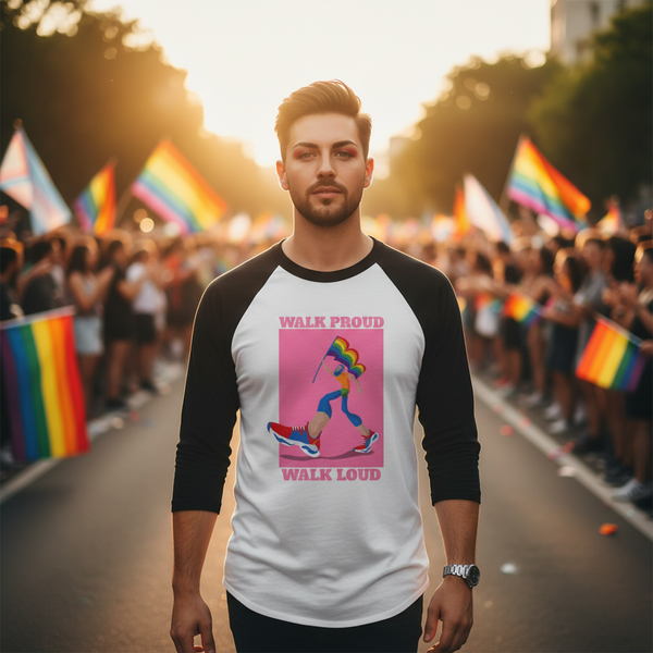 Person wearing a white-and-black raglan shirt reading “WALK PROUD WALK LOUD” at a Pride parade
