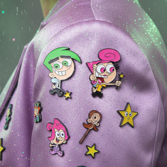 Wanda and Cosmo enamel pins with character and star designs on a purple glitter bag