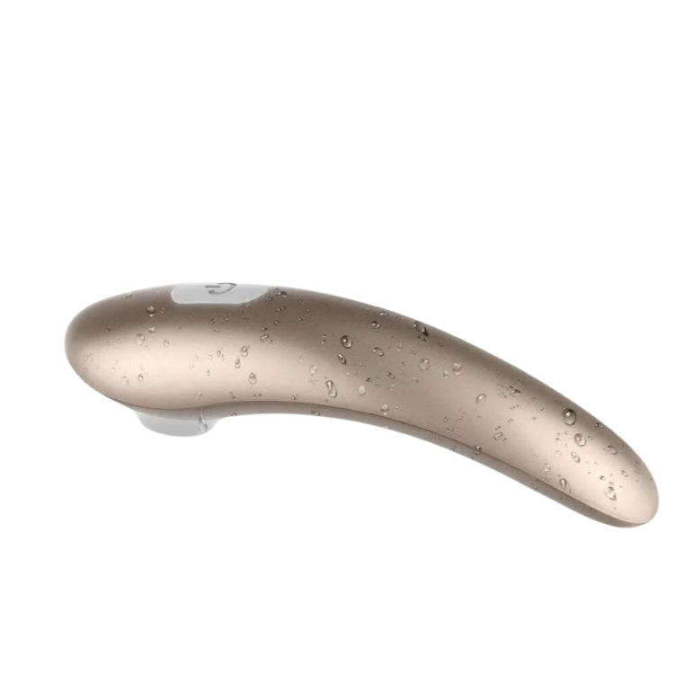 Curved taupe clitoral stimulator shown at an angle with water droplets and a top button