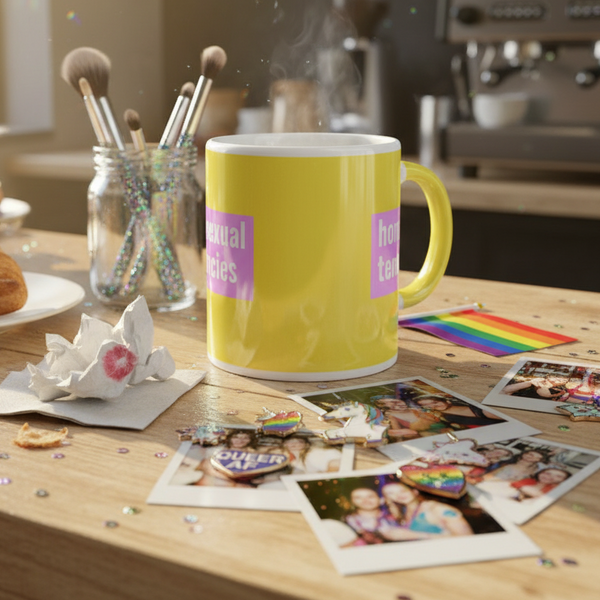 Yellow mug with pink “Homosexual Tendencies” lettering; queer mug with “Homosexual Tendencies” design