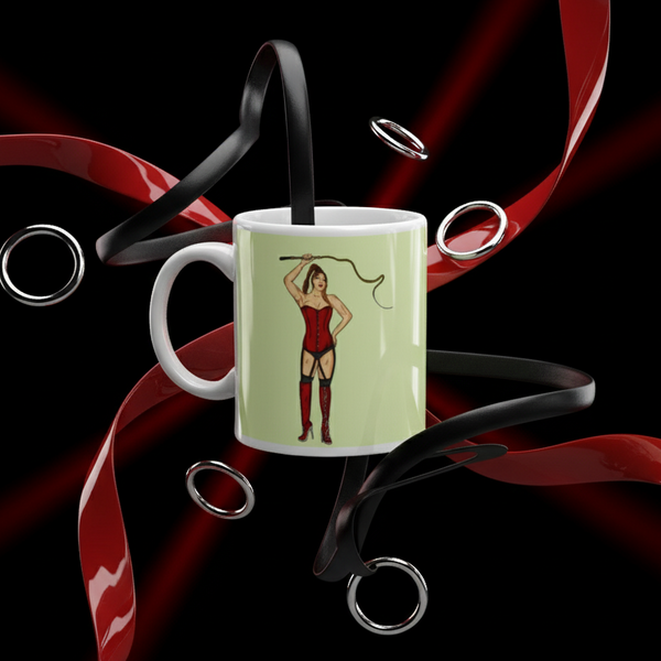 Dominatrix Mug featuring a bold pin-up illustration of a woman in a red corset and boots, surrounded by dynamic ribbons and metallic rings, reflecting queer pride and visibility.