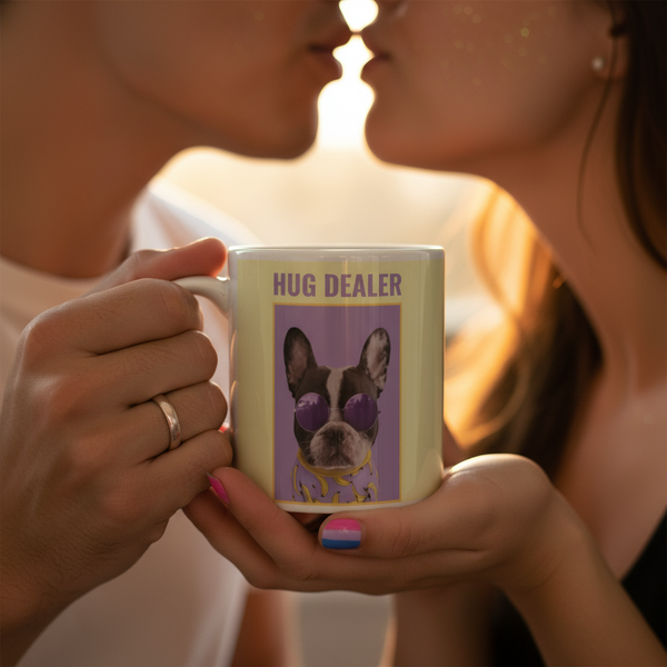 Close-up of two people sharing a moment with the Hug Dealer Mug, featuring a French bulldog in sunglasses. Perfect for expressing LGBTQIA+ pride and self-expression with every sip.