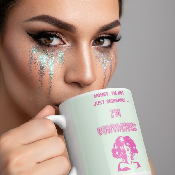 Close-up of a face with glitter tears and bold makeup holding an I'm Contagious Mug in pastel-mint, celebrating LGBTQIA+ pride with a humorous, empowering message in pink.