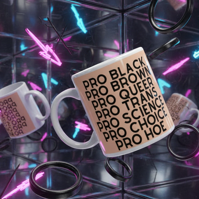 White ceramic Pro Hoe mug featuring bold black text against a light tan background, advocating LGBTQIA+ pride and empowerment, displayed in a vibrant, mirrored neon-lit space with floating reflections.