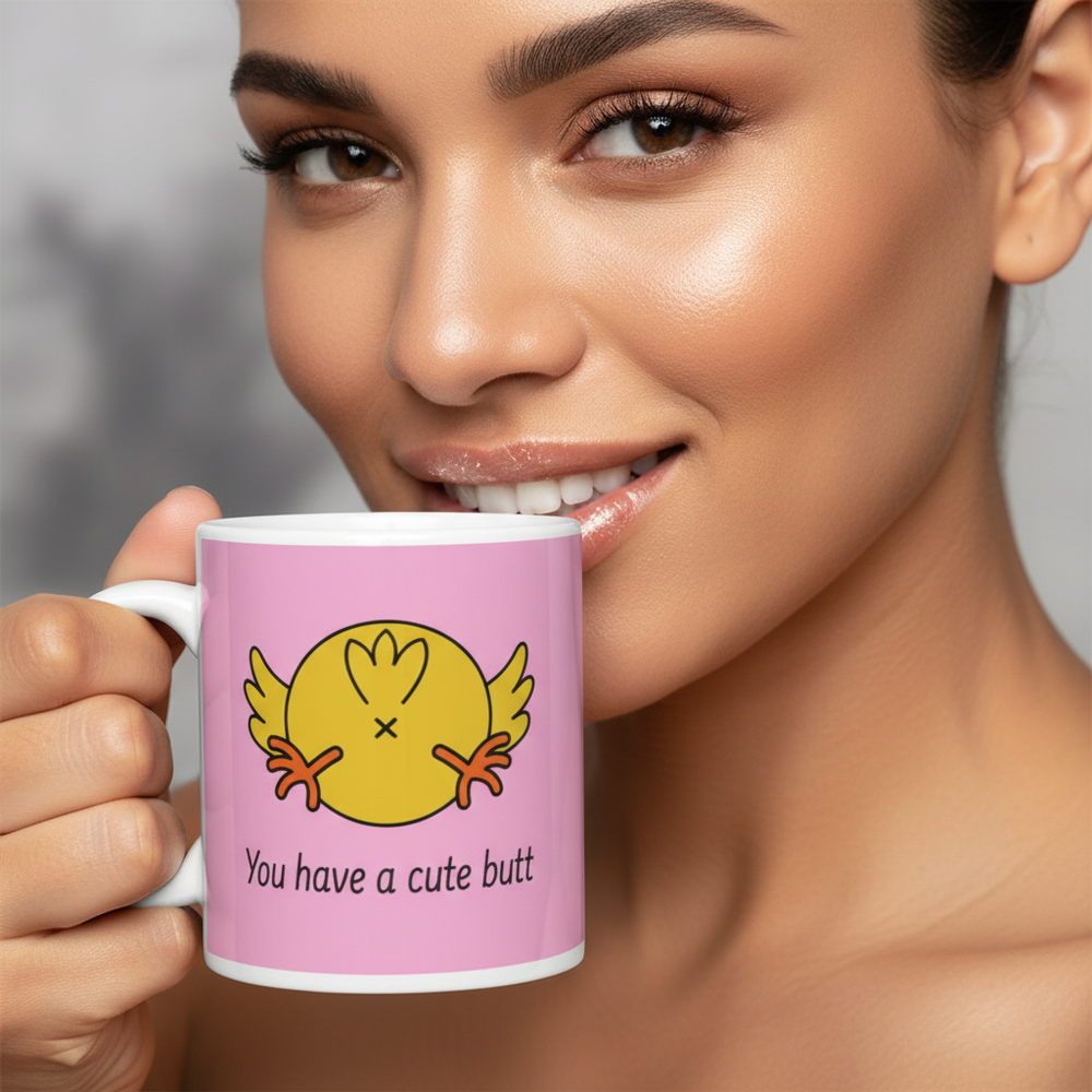 Close-up of a person holding a pink mug reading “You have a cute butt”