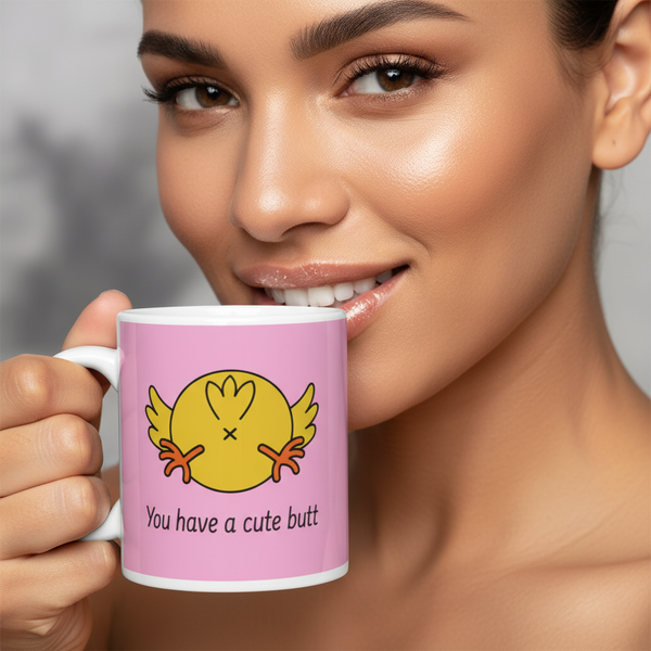 Close-up of a person holding a pink mug reading “You have a cute butt”
