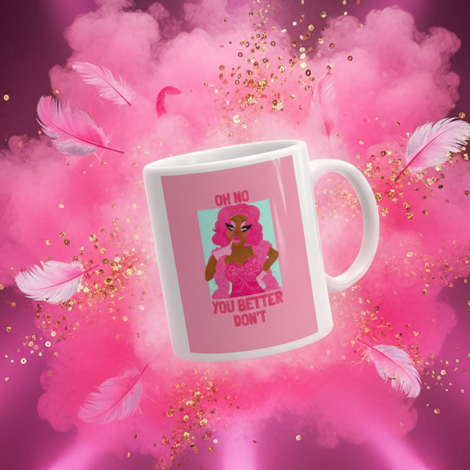 The Oh No You Betta Don't Mug features a fierce, pink-haired cartoon figure in sparkly evening wear, exuding bold queer energy. Perfect for celebrating pride, visibility, and self-expression with every sip.