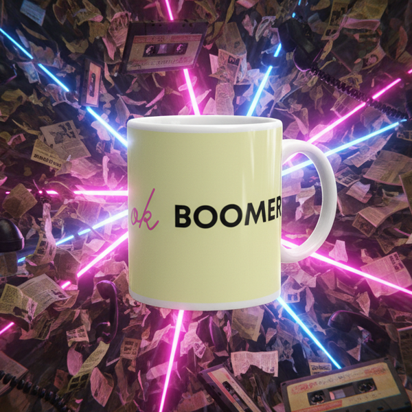 Floating Ok Boomer Mug in soft pastel yellow with vibrant ok and bold BOOMER text; surrounded by retro elements, embodying queer pride and nostalgic empowerment from Queer In The World.