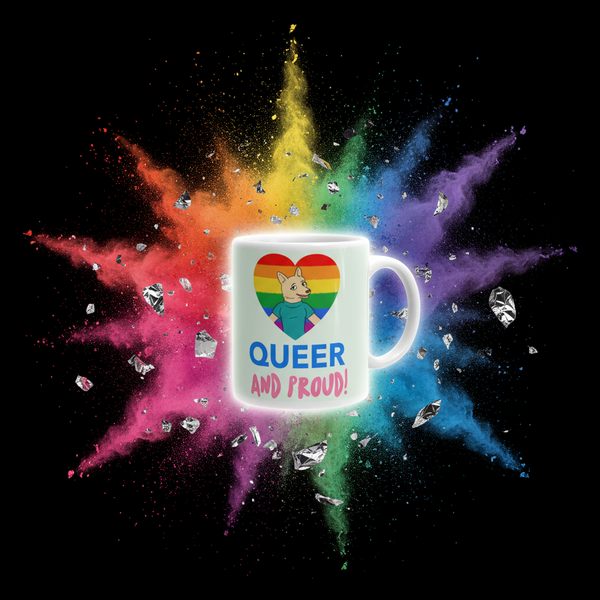 White mug with a rainbow heart, cartoon dog, and “QUEER AND PROUD!” text