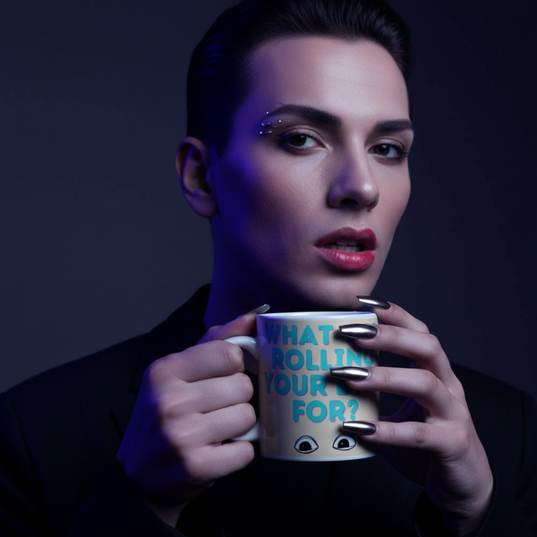 Person holding White mug with turquoise text and cartoon eyes; mug with “What You Rolling Your Eyes For?” design