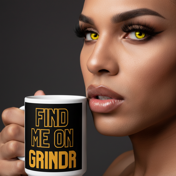 Close-up person holding a white mug reading “FIND ME ON GRINDR” beside their face