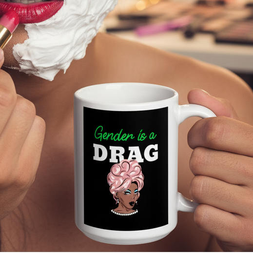 Close-up of hands holding the Gender Is A Drag Mug featuring a drag-queen design, while applying lipstick. The mug embodies vibrant queer pride and self-expression, perfect for celebrating LGBTQIA+ identities.