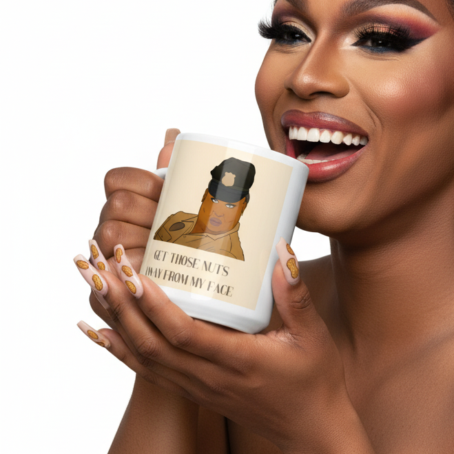 Glamorous person holds a mug reading “Get Those Nuts Away From My Face”