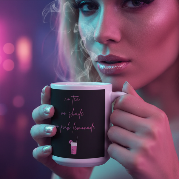 Person holding the No Tea No Shade No Pink Lemonade Mug with steam rising, nails in sparkly polish. Mug features a pink drink graphic, reflecting Queer In The World's vibrant, prideful spirit.