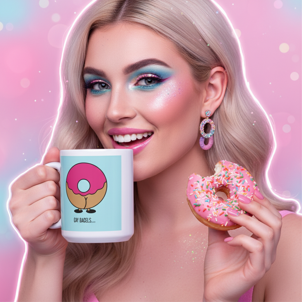 Person holds a mug with a cartoon bagel and “GAY BAGELS...” text beside a pink-frosted doughnut