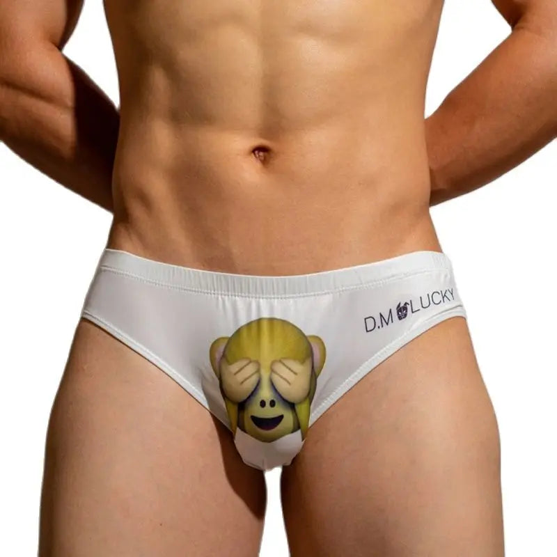 Front view of a person wearing white briefs with a see-no-evil monkey graphic and D.M LUCKY text