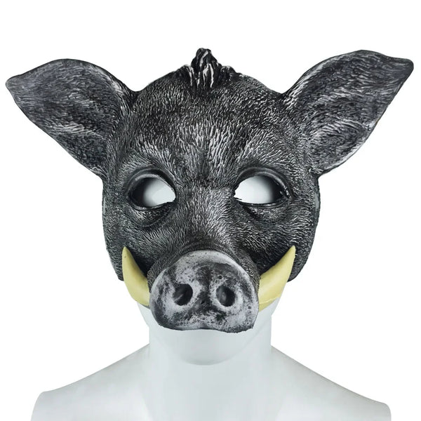Front-facing black boar mask on a white mannequin, with tusks and a large snout