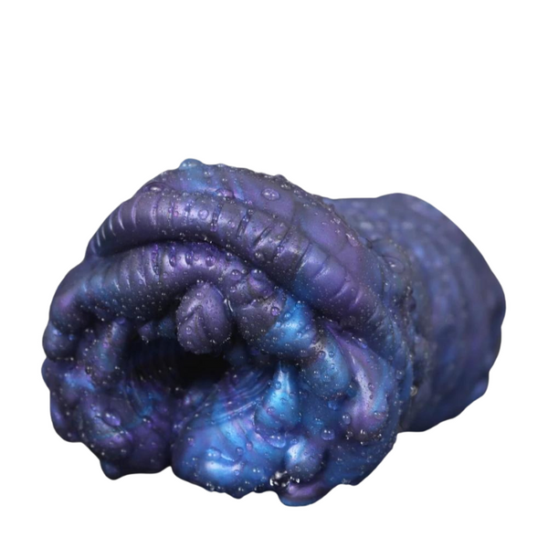 Close-up front view of a dark blue-purple textured oral masturbator with a central opening