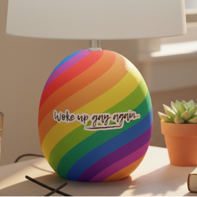 Woke Up Gay Again Bubble-Free Stickers with rainbow stripes decorate a white-shaded lamp